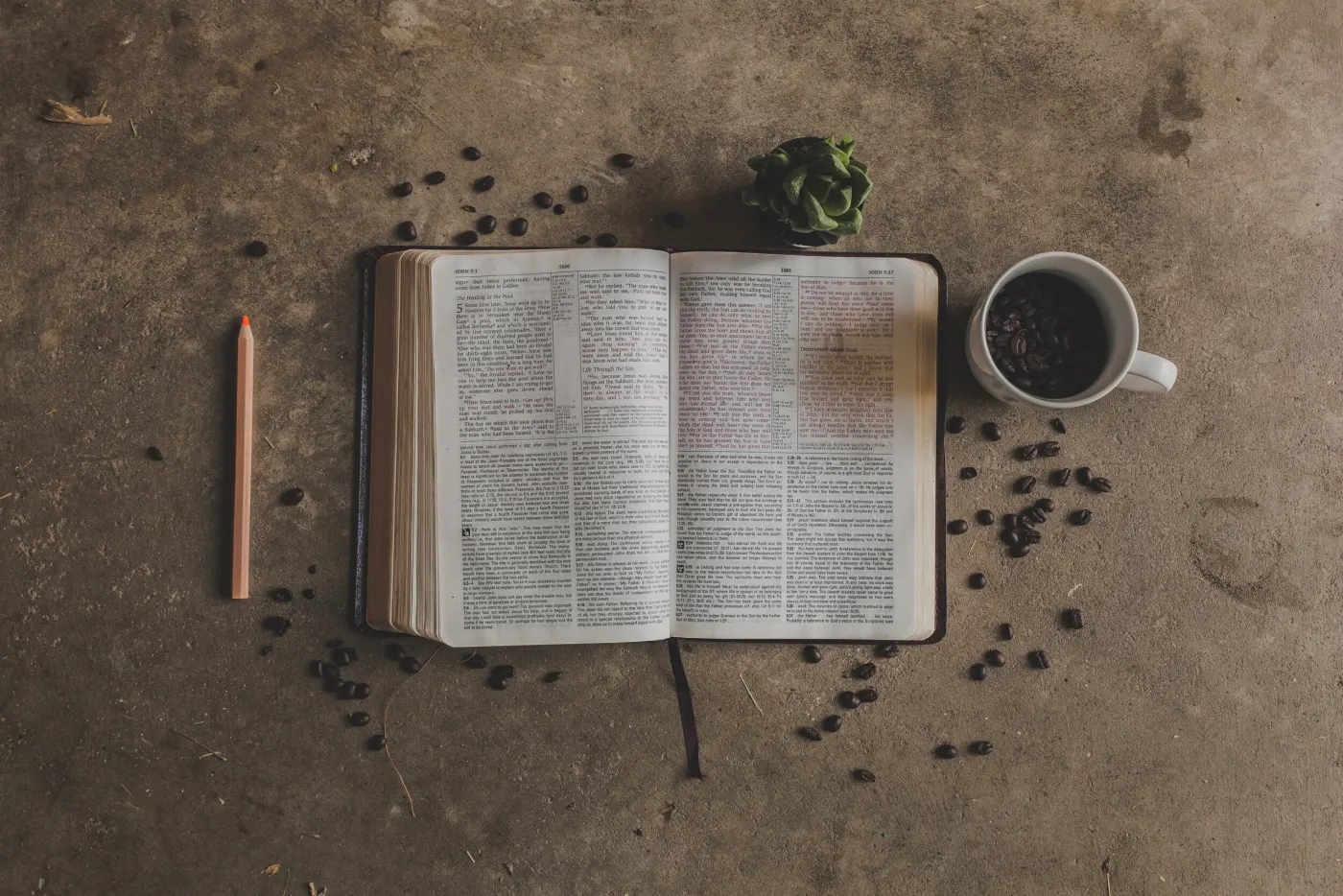 An open Bible and notebook set out for quiet study